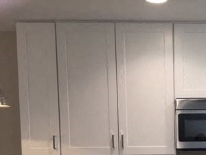 Lakeridge East & West | Kitchen Apartments for Rent in South Reno - Lakeridge Living Kitchen with White Cabinetry, Wood Plank Flooring, Stainless Appliances, and Quartz Countertops